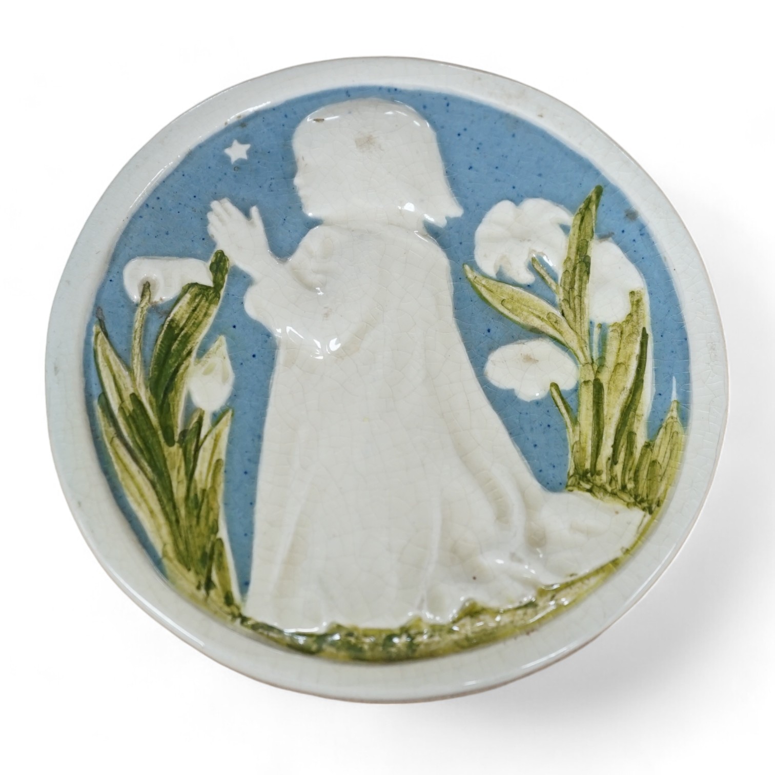 A small Della Robbia circular ceramic wall plaque of a child praying, signed to the base, 10.5cm in diameter. Condition - fair to good